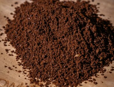 Close-up of coffee grounds on a wooden surface, showcasing the texture and aroma.