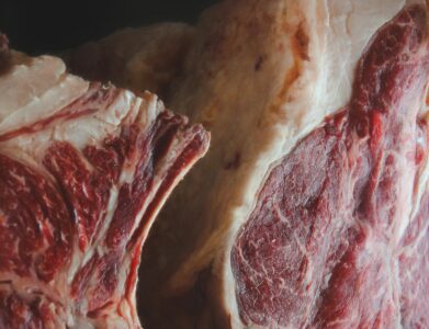 Detailed view of raw beef showcasing marbling and texture, ready for culinary use.