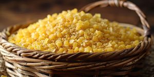 A woven basket filled with yellow grains, showcasing natural food ingredients.