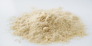 asafoetida aromatic powder on a white acrylic background.