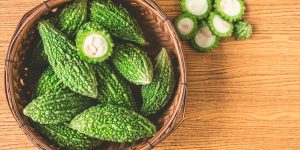 Bitter melon or bitter gourd in wooden basket. Free space for taxt