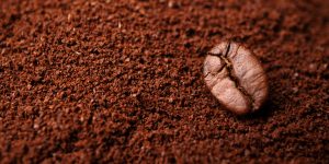Closeup of coffee beans at the mixed heap of roasted coffee with copy space for text. Concept of Coffee freshness