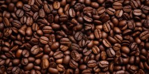 Closeup of Fragrant Roasted Coffee Beans Strewn Background. Generative AI.