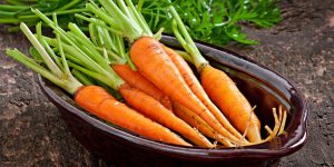 Fresh  carrots on old  wooden background