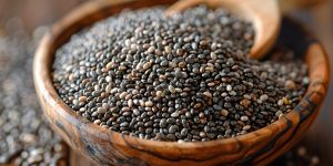 Fresh organic chia seeds are displayed in a beautifully designed wooden bowl with a wooden spoon, emphasizing their nutritional value and culinary versatility. perfect for health food blogs, superfood recipes, and dietary promotions. Generative AI