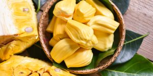 jackfruit on wooden basket with leaf, ripe jackfruit peeled tropical fruit fresh from jackfruit tree - top view