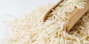 raw basmati rice on a white acrylic background.