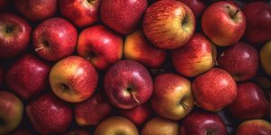Realistic photo of a bunch of red apples. top view fruit scenery