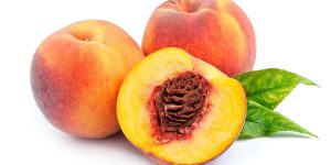 Sweet peach with leaves on a white background