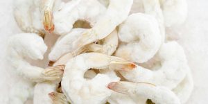 A detailed view of frozen shrimp with icy texture, perfect for culinary stock images.